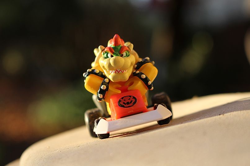 bowser with car in mario kart tour