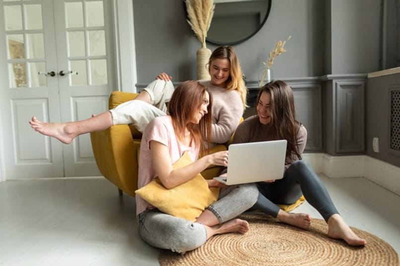 group of girls use a computer