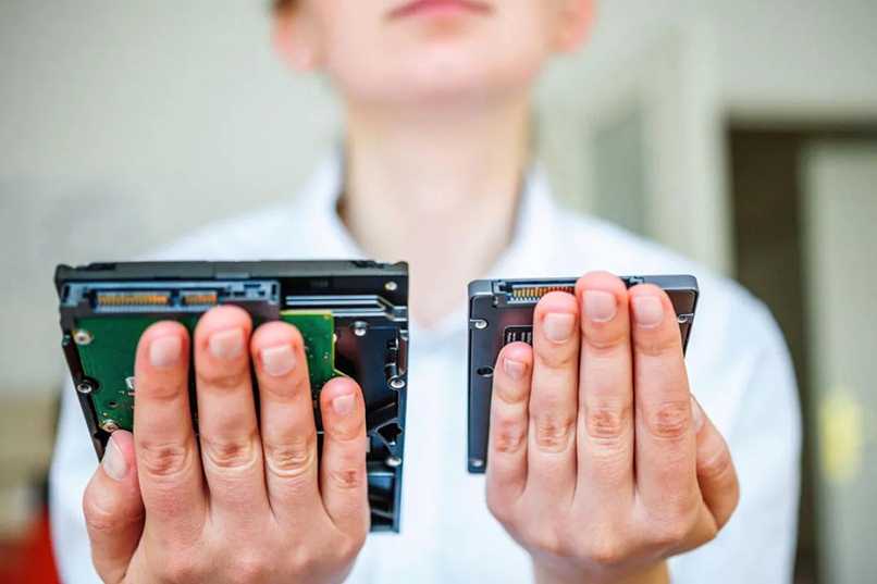 person with hard drives in hands