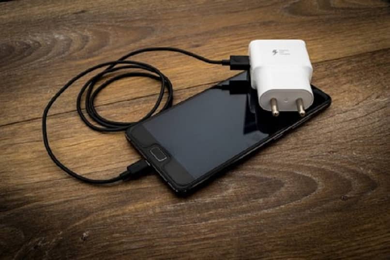 mobile device with its usb cable and white adapter 