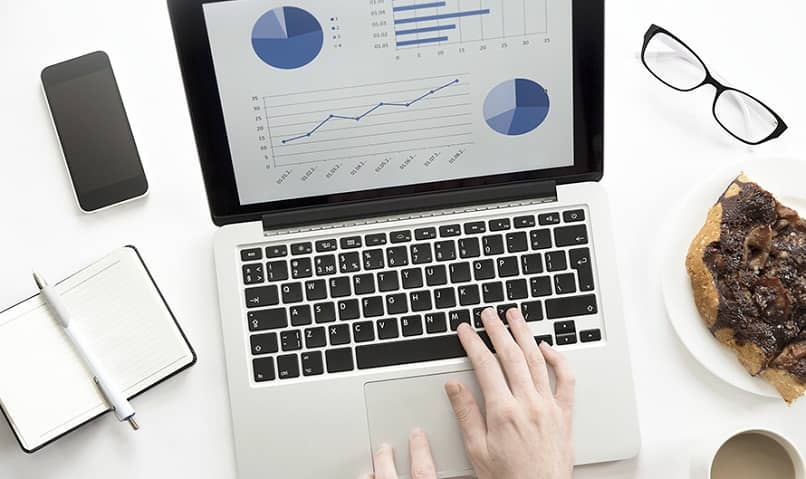 laptop with statistics on desk