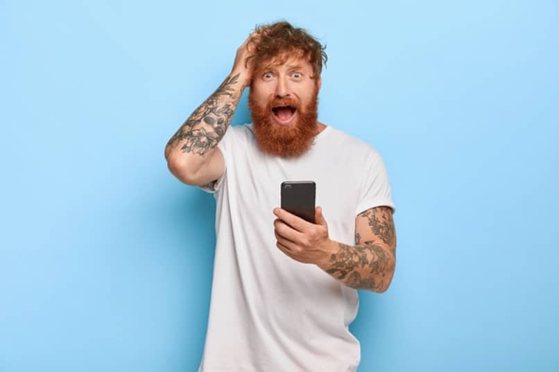surprised man holds phone