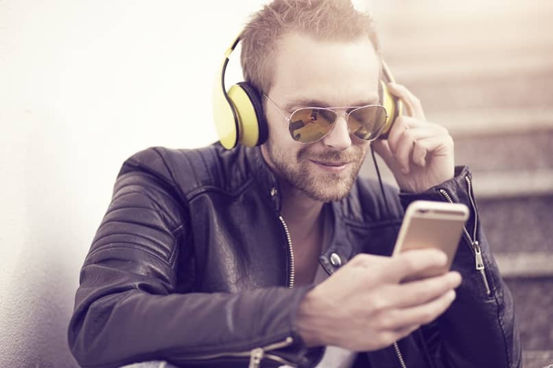 person using his mobile with headphones