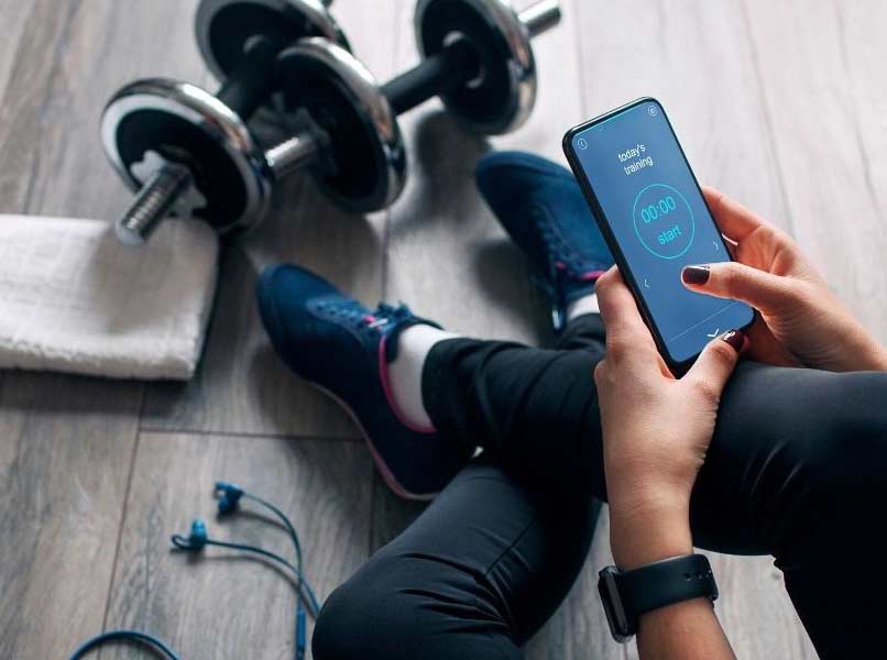 person using cell phone with fitness app