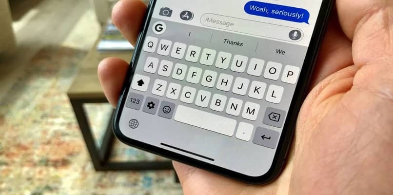 iphone in hand keyboard on screen